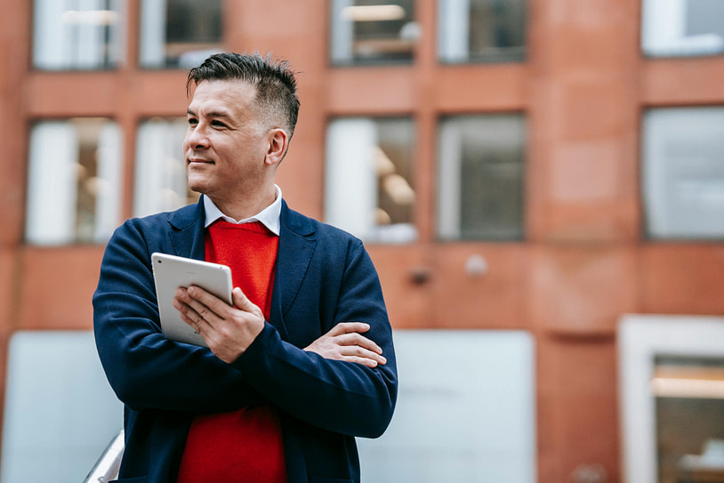 pexels-vanessa-garcia-6326311 person wearing red shirt with tab in hand